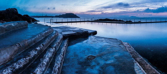 Guernsey Bathing Pools and Castle Cornet at sunrise, Channel Islands, United Kingdom