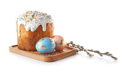 Wooden board with delicious Easter cake, pussy willow branches and eggs on white background