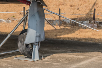 Port side landing gear on military aircraft on display in public park.