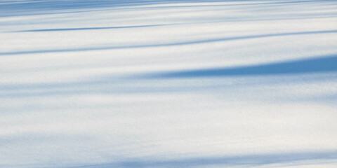 Striped shadows on a snowy surface