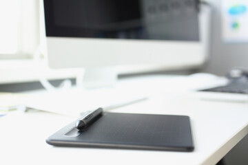 Modern workplace of designer with modern devices on table, tablet stylus and keyboard