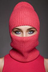 beautiful girl in red balaclava. Trendy Mask on pretty eyes woman - obrazy, fototapety, plakaty
