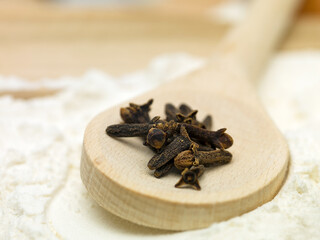 clove pieces placed on a wooden spoon