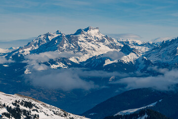 Beautiful snowcapped mountains with blue sky at the ski resort of Morzine in the Alps Mountain Range of France, Europe