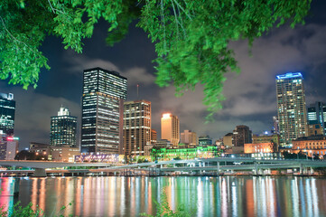 Trees on South Bank and the Reflection of Brisbane Skyline in Brisbane River at Night, Queensland,...