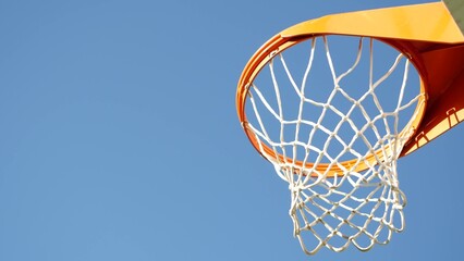 Basketball court outdoors, orange hoop, white net and backboard for basket ball game outside....