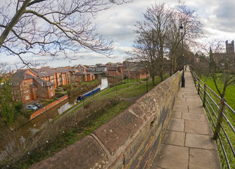 View of narrowboat moored on a British canal in urban setting
