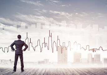 Motivation and inspiration concept with modern cityscape and businessman observing it