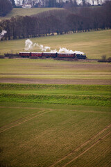 Fototapeta na wymiar Kent and East Sussex Railway steam train seen from Bodiam Castle, East Sussex, England, United Kingdom, Europe