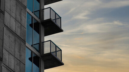 Panorama Puffy clouds at sunset Side of a tall building with railings on the balconies at Salt L