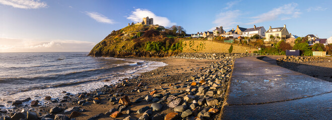 Criccieth Castle, above Criccieth Beach at sunrise, North Wales
