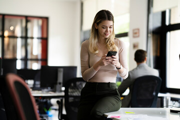 Businesswoman in office. Smiling businesswoman using the phone.