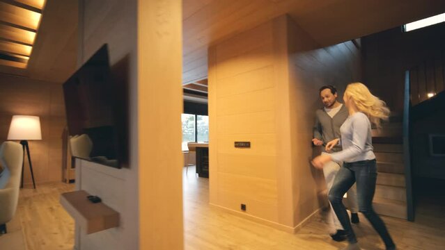 The romantic couple have fun at the beautiful wooden house. slow motion