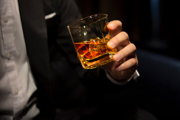 Closeup businessmen holding a glass of whiskey