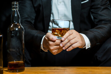 Closeup businessmen holding a glass of whiskey