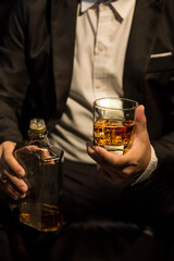 Closeup businessmen holding a glass of whiskey