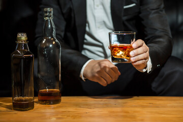 Closeup businessmen holding a glass of whiskey