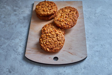 tasty homemade oat cookies on a wooden board