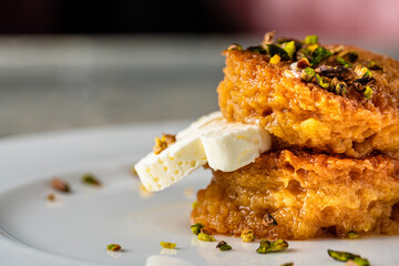 Bread kadayif or Ekmek Kadayifi with cream, a delicious Turkish dessert served in a fine dining...