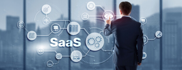 SaaS Software as a Service concept with man hand pressing text
