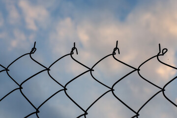 Wire mesh fence with sky nature background