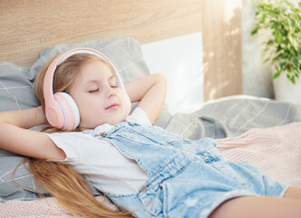 Cute girl listening music in the bedroom