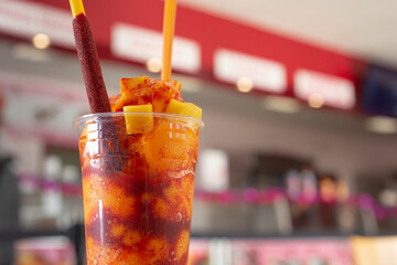 A view of a mangonada drink, on the left side of the frame.