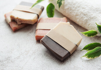 Handmade soap bars and green leaves