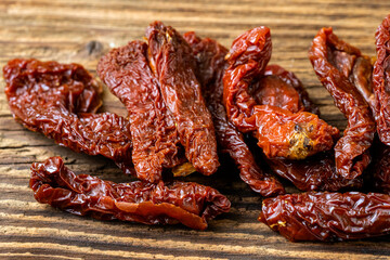Sun dried tomatoes on rustic wooden table