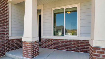 Panorama Porch exterior of a house with sliding glass window and bricks
