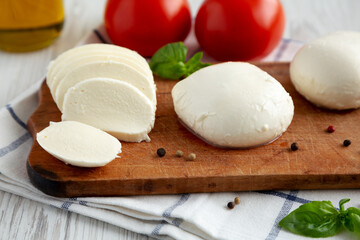 Homemade Mozzarella Cheese with Tomato, Basil and Olive Oil, side view. Close-up.
