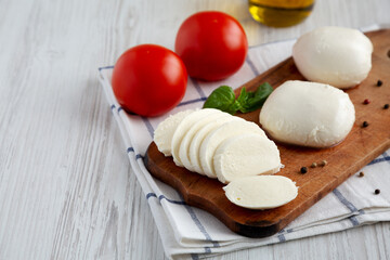 Homemade Mozzarella Cheese with Tomato, Basil and Olive Oil, low angle view. Copy space.
