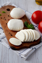 Homemade Mozzarella Cheese with Tomato, Basil and Olive Oil, side view.