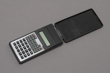 Scientific calculator against gray background.