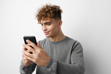 Fototapeta premium kinky guy with a phone in hand communication isolated background