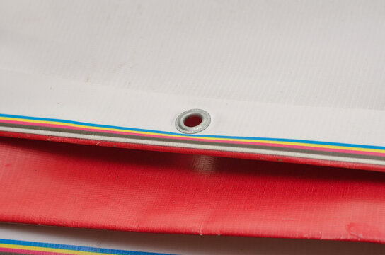 A red and white billboard. PVC fabric folded. Banner with eyelet