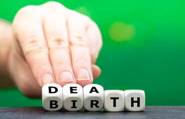 Symbol for the cycle of life. Hand turns dice and changes the word birth to death.