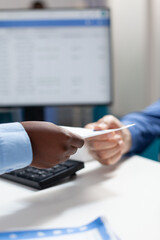 Closeup of african american therapist doctor woman giving paper with medication prescription to retired invalid senior man during medical appointment in hospital office. Medicine concept