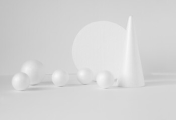 Geometric composition of white color: cone, a round stand surrounded by randomly scattered balls. Concept of demonstrating 3D objects