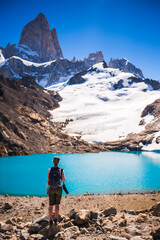 Hiker looking at view of Mount Fitz Roy, the glacier and Lago de los Tres, El Chalten, Patagonia,...