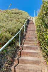 Fototapeta na wymiar Uphill trail with wooden steps at San Clemente, California
