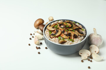 Concept of tasty food with risotto with mushrooms on white background