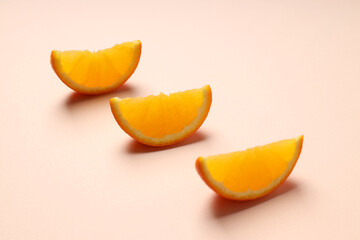 Orange slices on beige background, close up