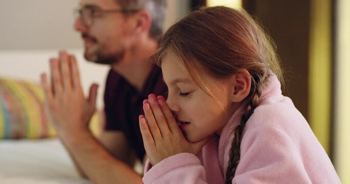 Thank God for dads. 4k video footage of a father praying together with his daughter before bedtime.