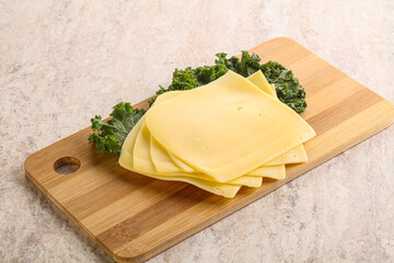 Sliced Gouda cheese over board