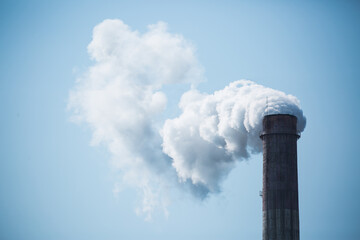 Working factory. Smoke from the factory chimney. Ecological pollution. Air emissions polluting the city. Industrial waste is hazardous to health. Large factory in smog, Production in operation.