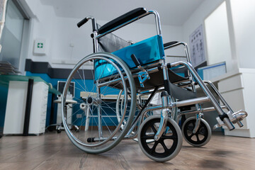 Empty office space with nobody in it having medical wheelchair for invalid patient. Hospital room...