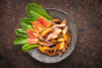 juicy sliced grill beef fillet steak meat in wabi sabi plate on rusty texture background, top view, flat lay