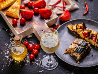 Tasty Seafood and Wine. Baked mackerel, bruschetta with cheese and tomato, fresh juicy tomatoes....