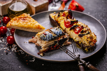 Close-up Bruschetta with cheese and tomato, baked mackerel, fresh juicy tomatoes. White wine and seafood. Still life mediterranean cuisine